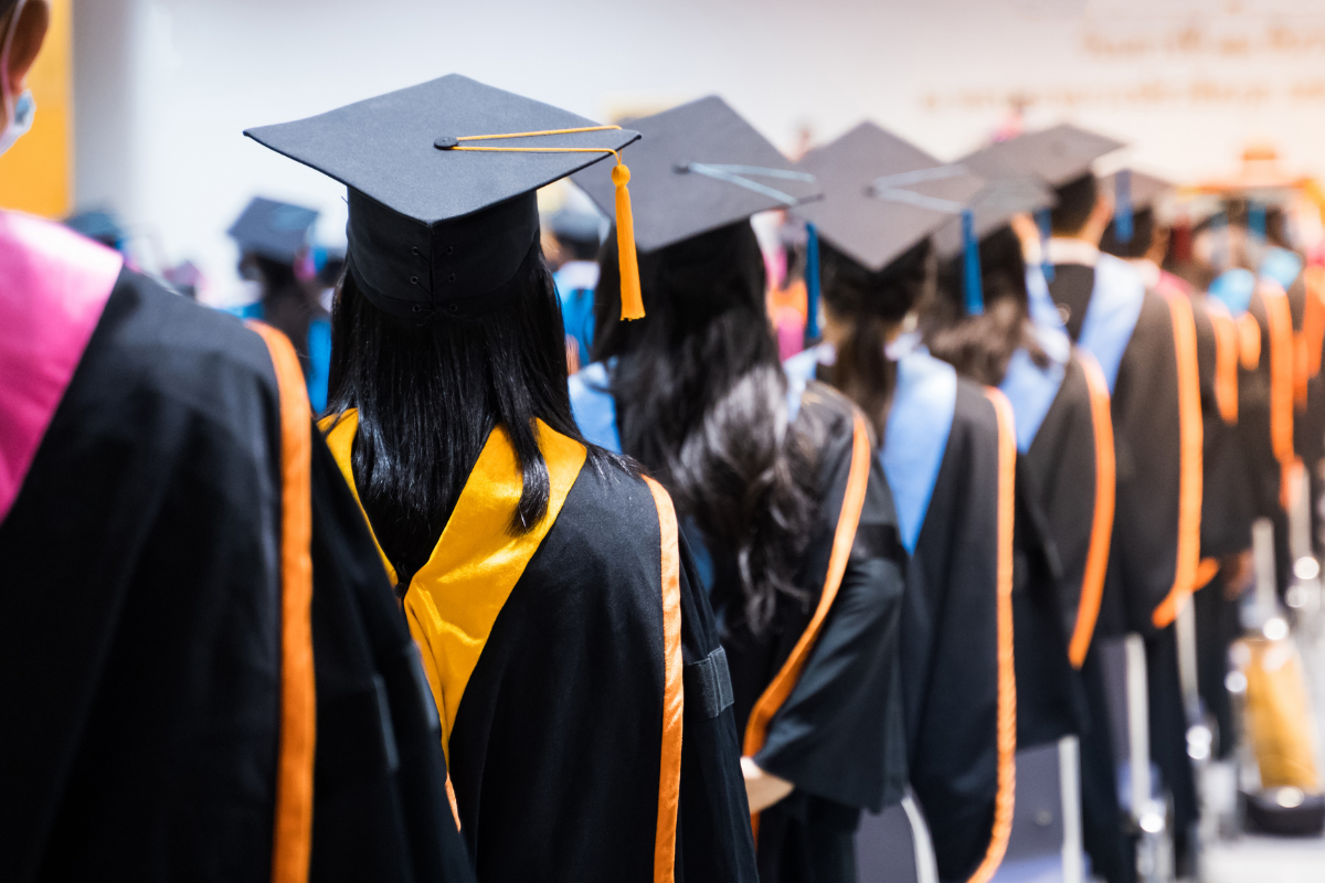A line of graduates waiting to collect their diplomas