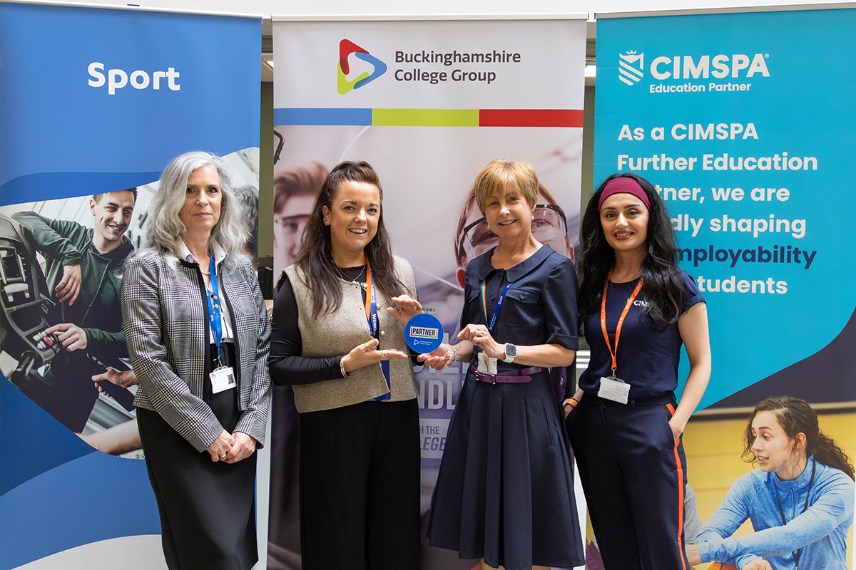 Bucks College Group Principal, Jenny Craig, presents partner plaque to CIMSPA's Micki Ruggins, joined by colleagues from both organisations.
