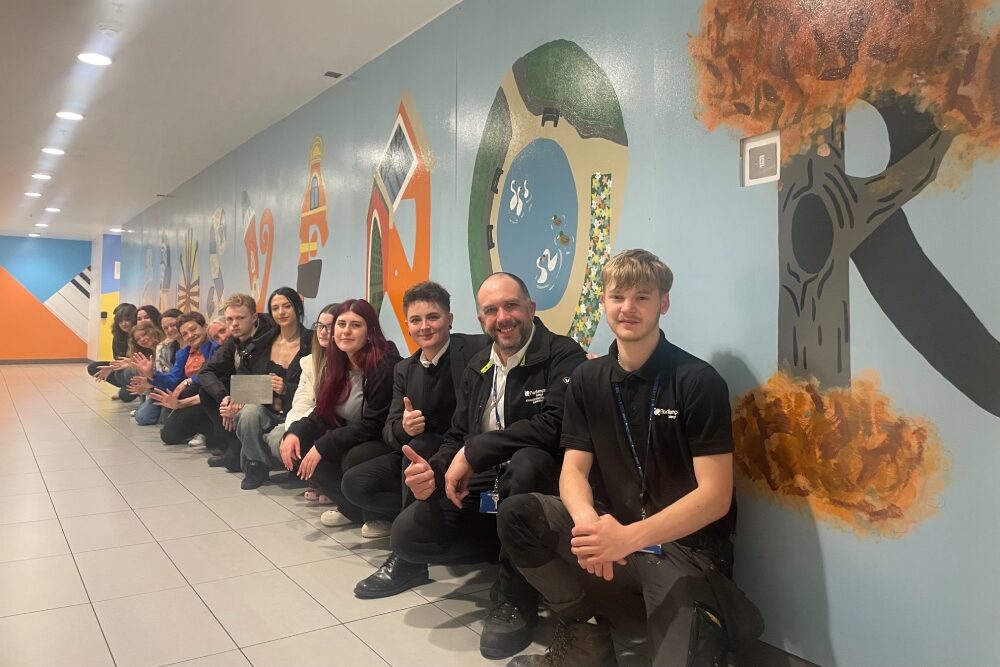 Northampton College staff and students with the mural